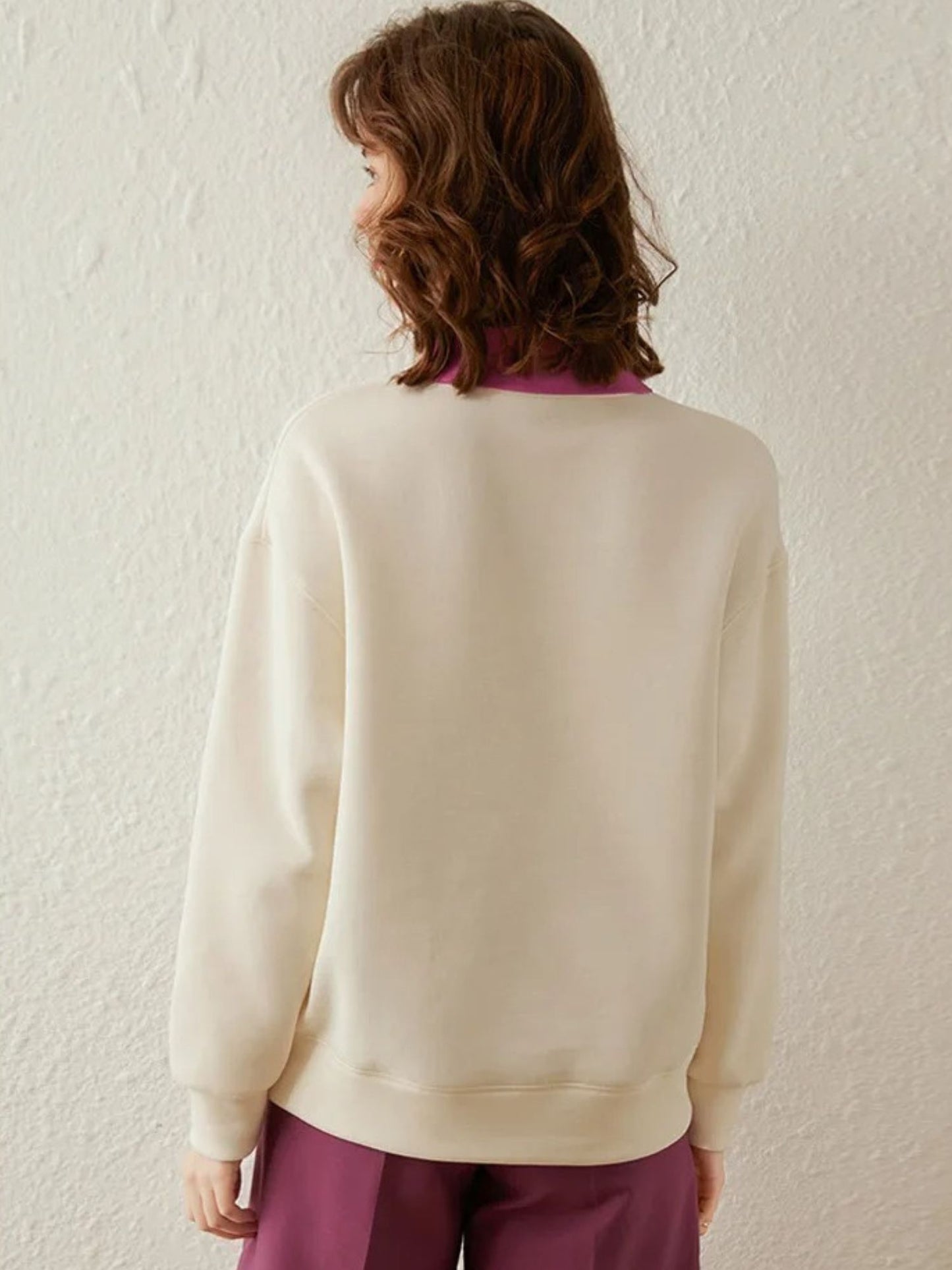 Back view of ivory sweatshirt with plain design and long sleeves