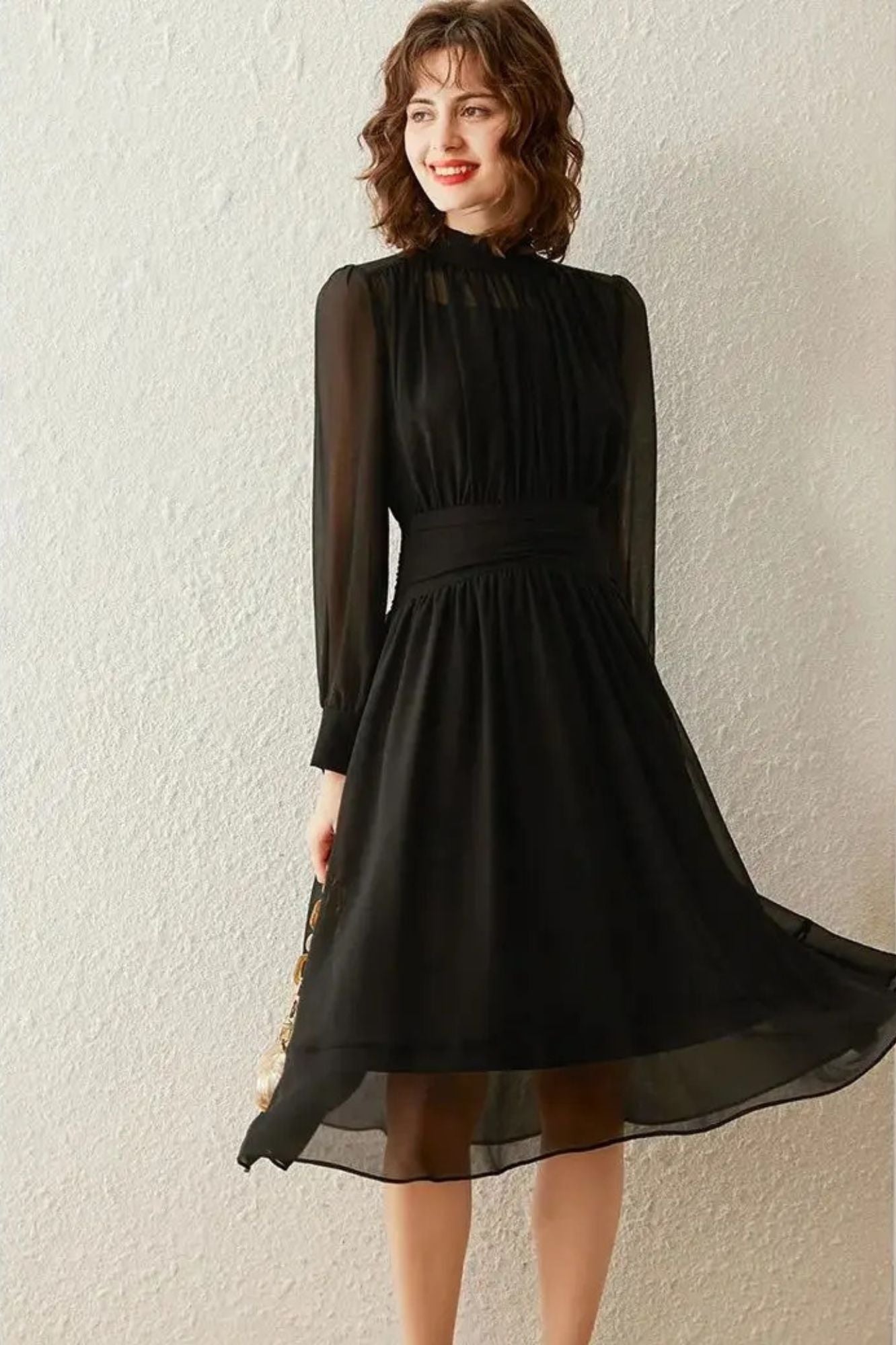 Full-body shot of black pleated midi dress with high neckline
