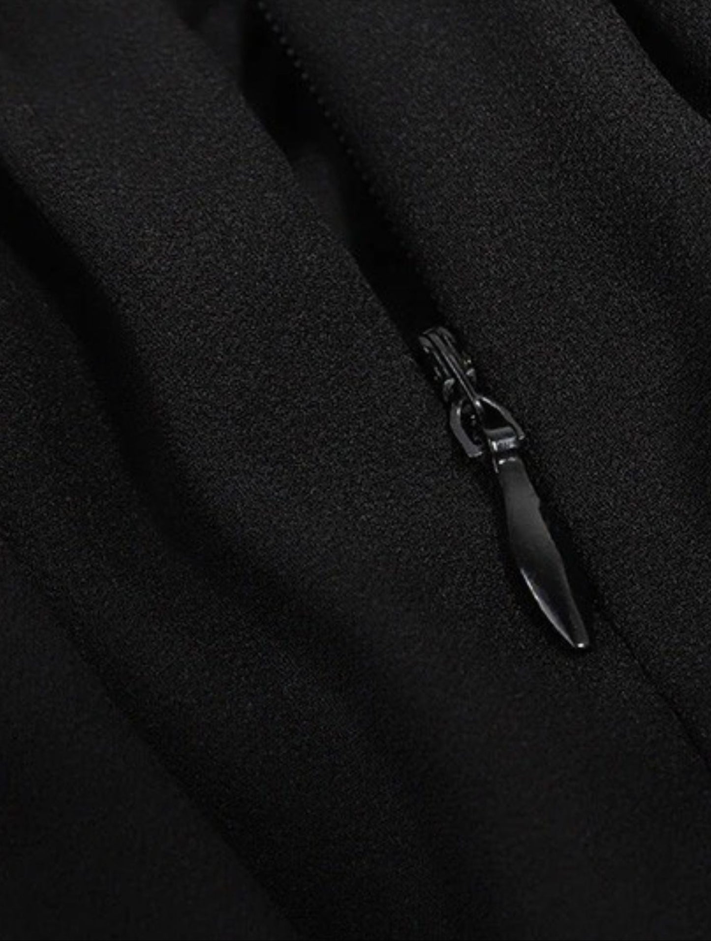 Close-up detail of black dress zipper on the back