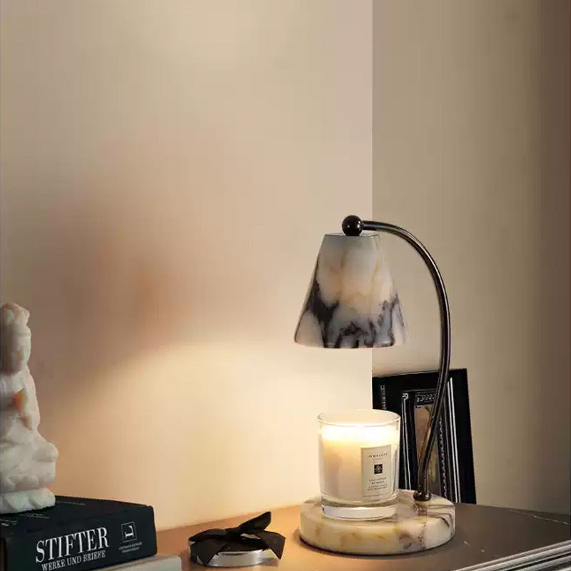 Marble bedside lamp with integrated candle tray and curved metal arm