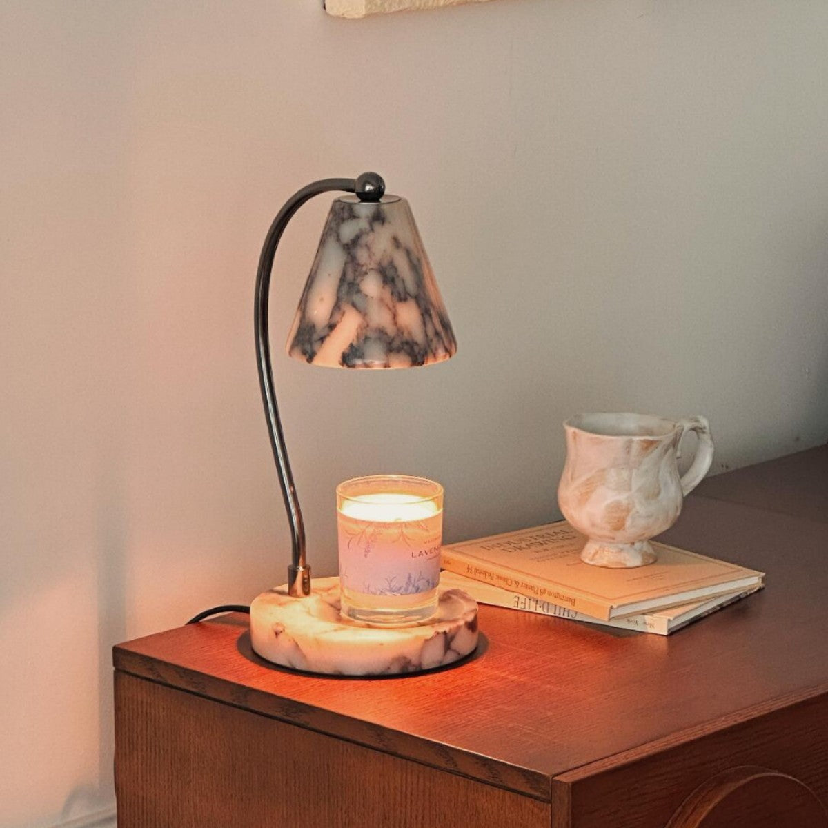 Marble bedside lamp with integrated candle tray and curved metal arm