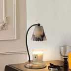 Marble bedside lamp with integrated candle tray and curved metal arm